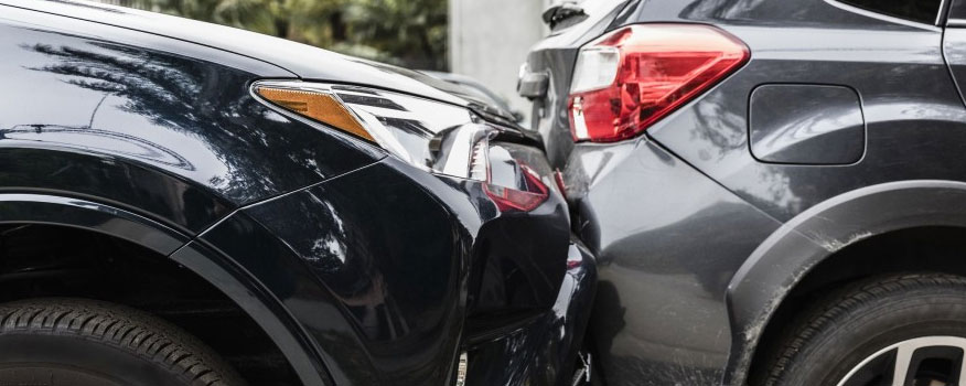 Rear-end car collision showing impact on vehicles